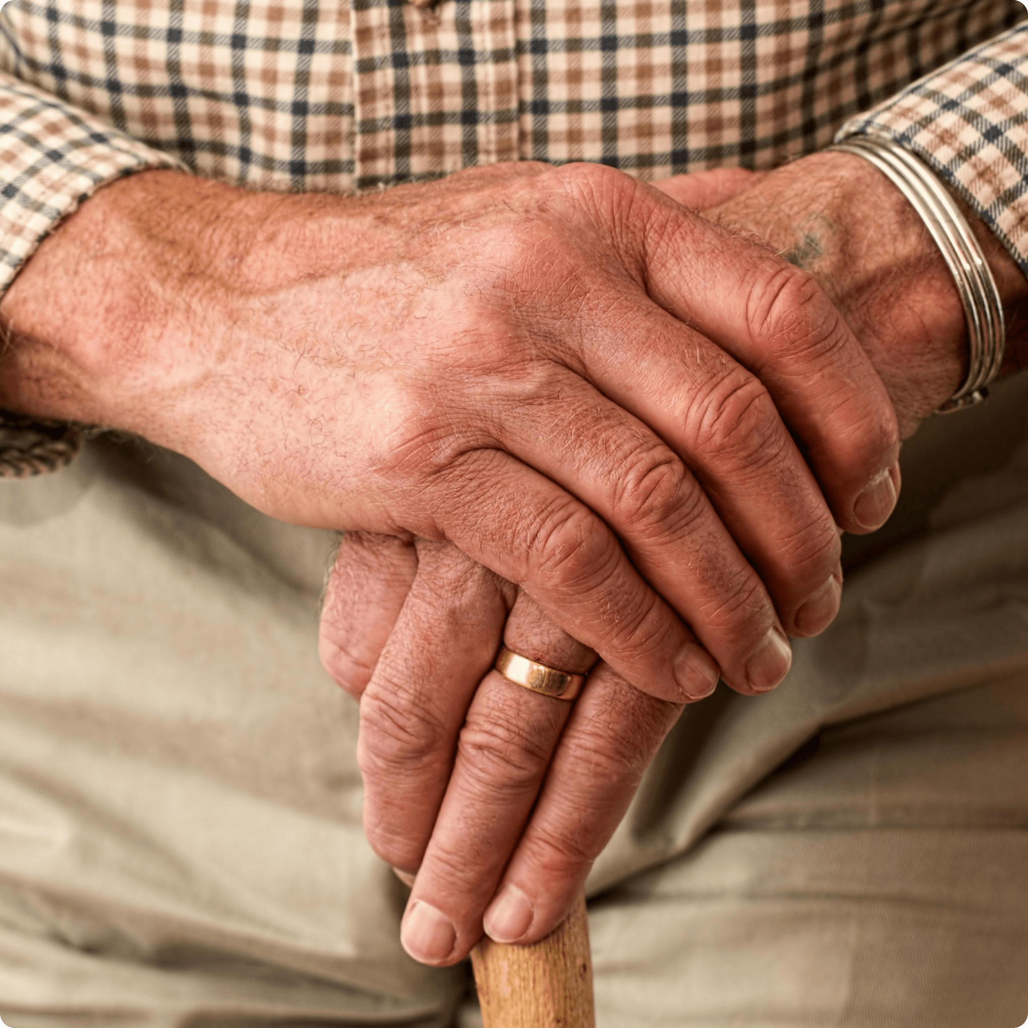 Close up of an elderly man's hands folded on top of each other